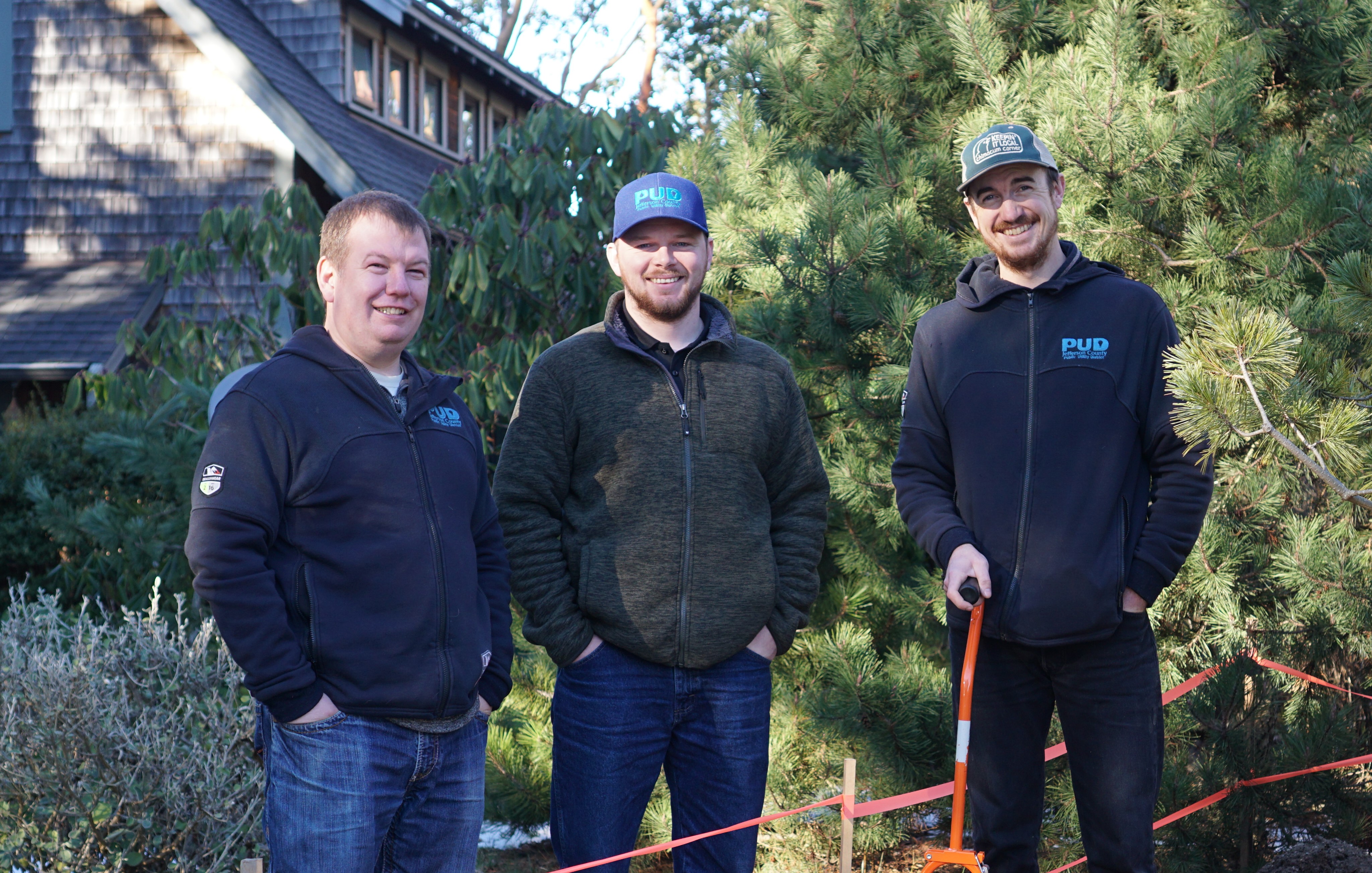 Three PUD staff posing infront of taped off area