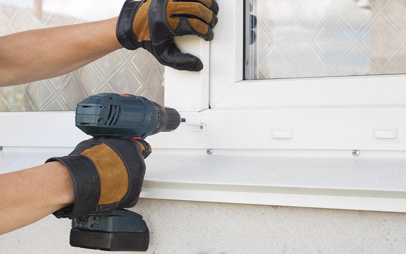 construction worker sets of metal and plastic window