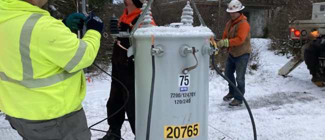 PUD crew working with a transformer in the snow