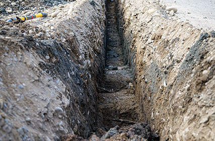 Trench dug out on the side of the road for undergrounding project