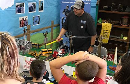 PUD staff demonstrating electrical safety at the Power Town display booth