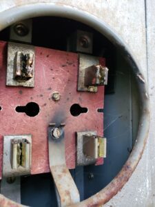 Image showing inside the meter housing. Damaged meter jaws requiring an electrician to repair.