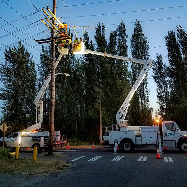 Linemen in crane bucket