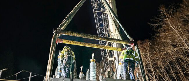 Substation crews working the middle of the night to place a new transformer at the Port Ludlow Substation. Crews climb to the top of the transformer to connect to the system.