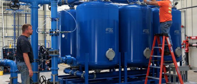 Water crew check one of the large filtration systems at the PUD sparking well in Hadlock.