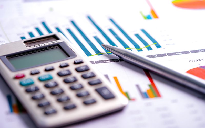 Calculator on chart and graph spreadsheet paper. Finance development, Banking Account, Statistics, Investment Analytic research data economy, Stock exchange trading, Business company concept.