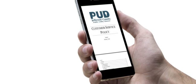 Person holding phone with PUD customer service policy