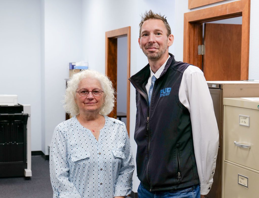 PUD Program Specialist, Drew McKnight and Kathy Sculley, OlyCAP Energy Assistance Program Manager at OlyCAP Port Angeles office.