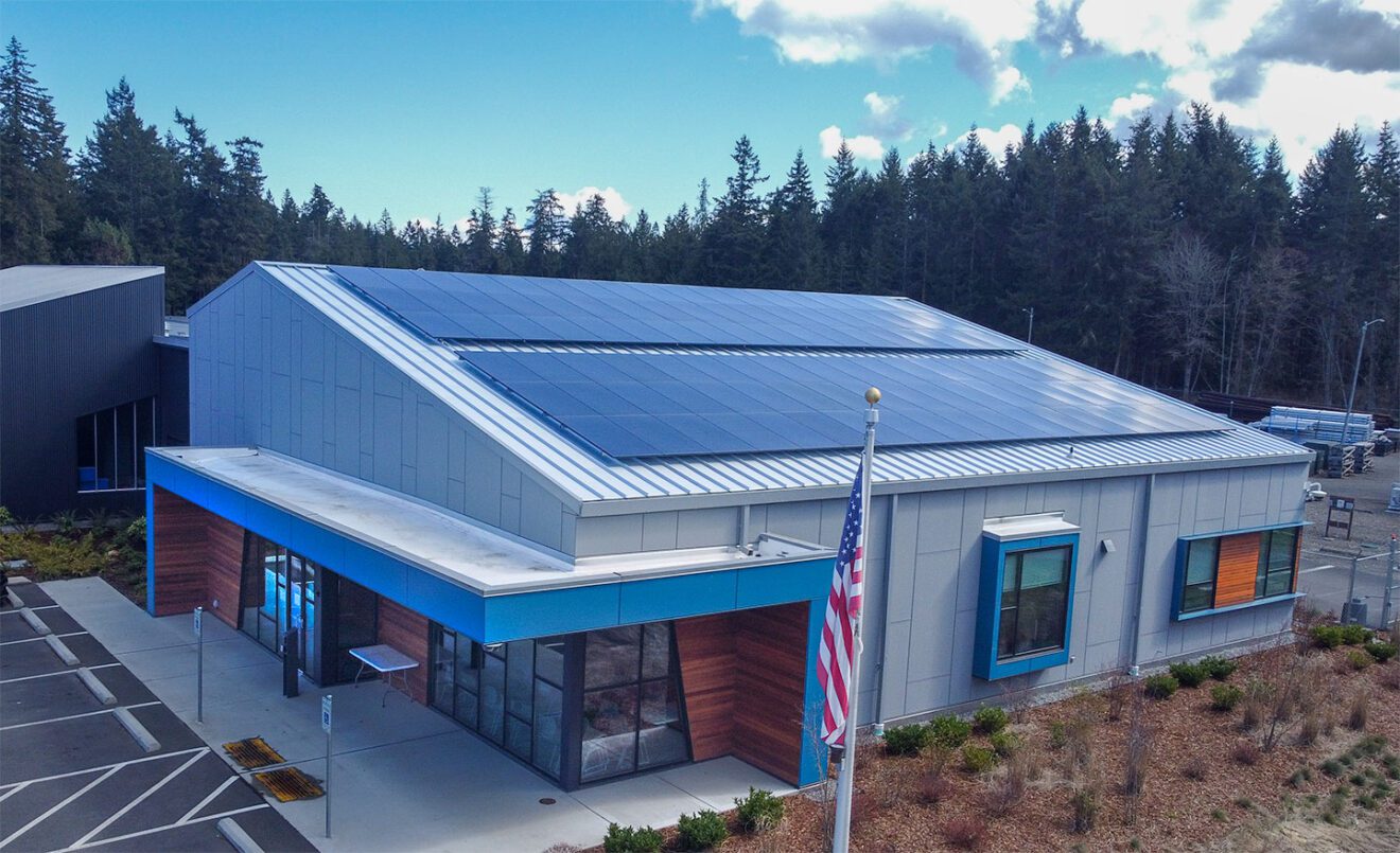 Image of the 310 PUD headquarter customer service lobby from outside with the solar panels visible.