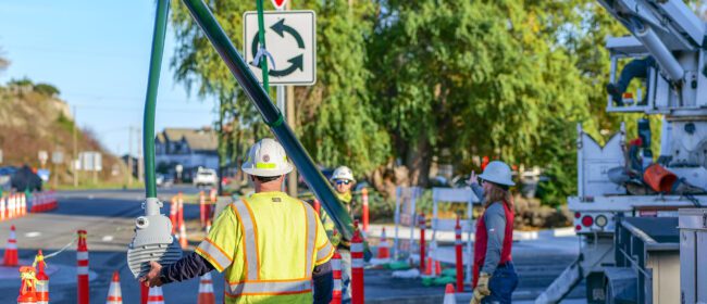 Image of PUD line crew installing a new light pole along the SR20 and Kearney Street roundabout in Port Townsend.