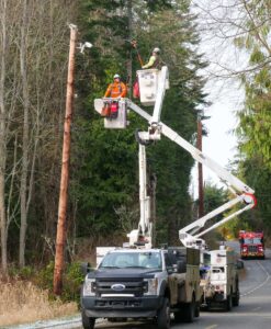 PUD line crew in bucket trucks.