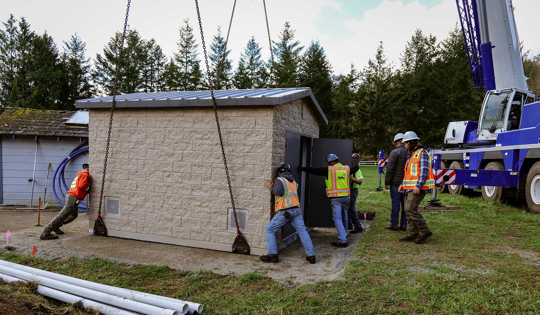 Crew push to position the concrete building.