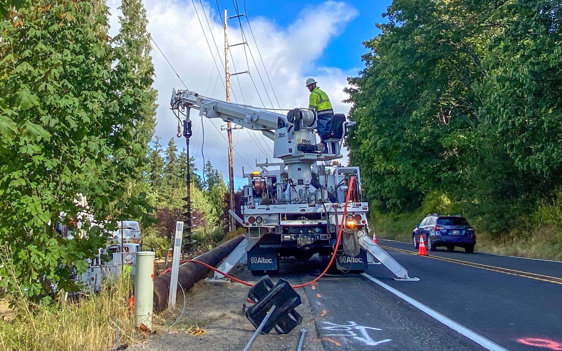 linemen replacing a utility pole