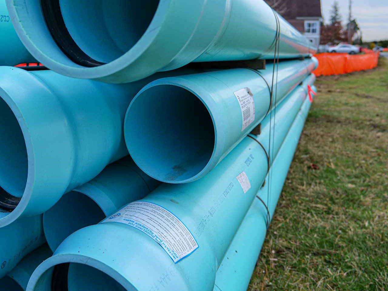 Picture of blue water pipes bundled up near a road