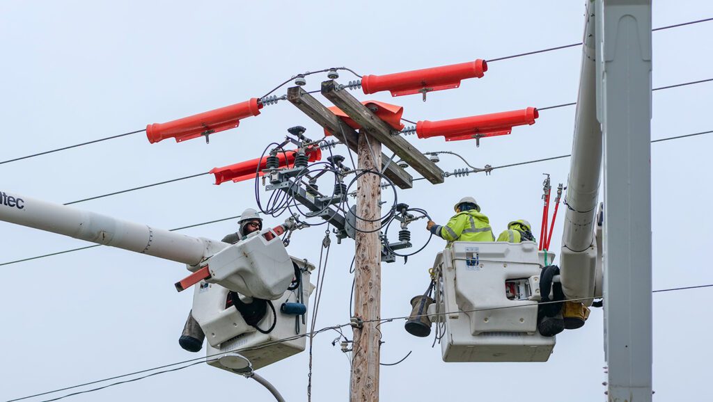 PUD line crew in two buckets installing a switch